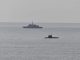 A French Navy vessel watches the surfaced Russian sub Novorossiysk this week.