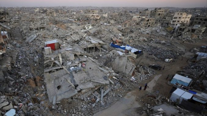 People walk among extensive rubble and destroyed buildings in Gaza City during a ceasefire.