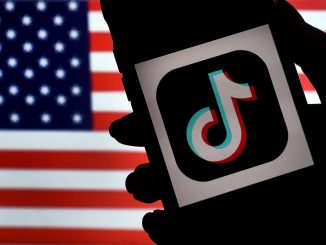 In this photo illustration, the social media application logo, TikTok is displayed on the screen of an iPhone on an American flag background on August 3, 2020 in Arlington, Virginia. - The US Senate voted on August 6, 2020, to bar TikTok from being downloaded onto US government employees' telephones, intensifying US scrutiny of the popular Chinese-owned video app. The bill passed by the Republican controlled Senate now goes to the House of Representatives, led by Democrats. (Photo by Olivier DOULIERY / AFP) (Photo by OLIVIER DOULIERY/AFP via Getty Images)
