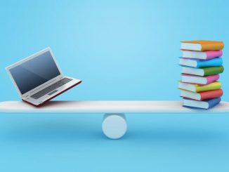 Books balanced on a see saw with a laptop