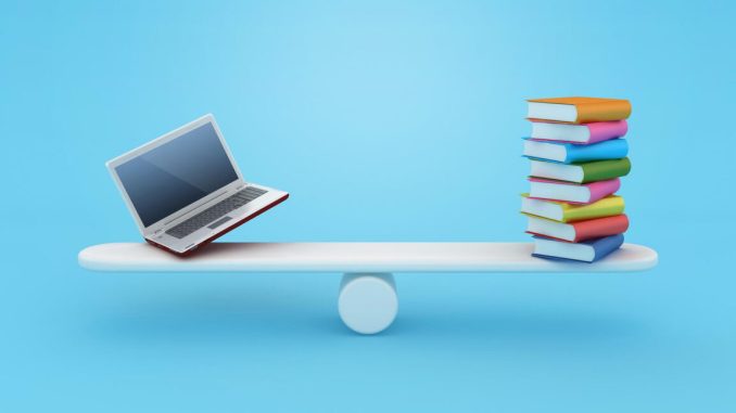 Books balanced on a see saw with a laptop