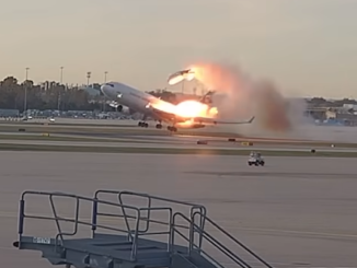 Still image from a video showing a cargo plane taking off while fire engulfs a wing and the left engine having detached. The crash of UPS flight 2976 killed three pilots aboard the aircraft and killed a dozen more people on the ground, with 23 people being injured.