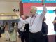 Police escort Dr. Steven Kahn out of a medical conference in New Orleans for handling out copies