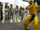 Children watch a martial arts performance by Unitree robots at a humanoid robot store on June 1, 2026 in Zhengzhou, Henan Province of China. The robot is wearing yellow martial arts clothing.