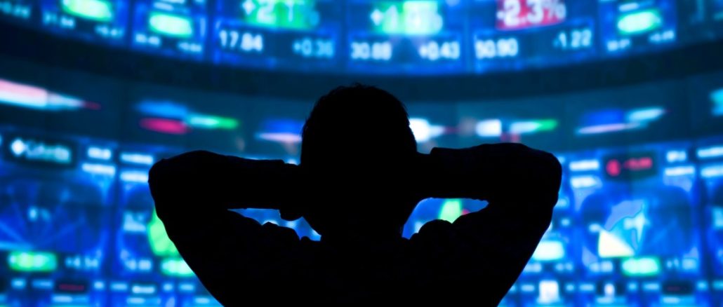 young man standing in front of the projection reflected stock market