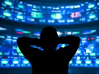 young man standing in front of the projection reflected stock market