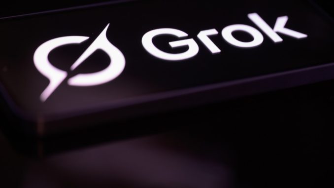 The Grok logo is displayed on a mobile phone screen