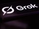 The Grok logo is displayed on a mobile phone screen