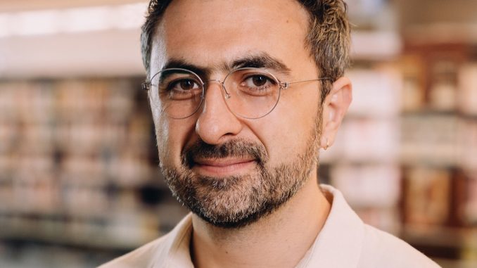 Photo of Microsoft AI CEO Mustafa Suleyman as he warns that Anthropic risks AI alignment failures by training Claude to view itself as a conscious entity deserving of legal rights.