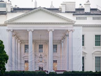 A protective tarp with a photo on it covers the scaffolding and the columns on the North Portico of the White House on July 18, 2026 in Washington, DC..