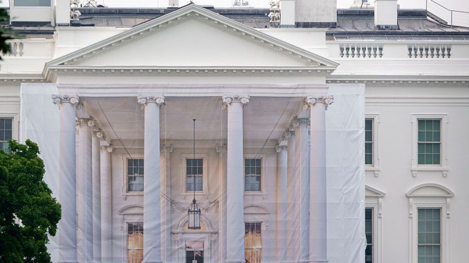 A protective tarp with a photo on it covers the scaffolding and the columns on the North Portico of the White House on July 18, 2026 in Washington, DC..