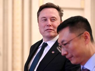 Tech billionaire and Tesla founder Elon Musk walks through the Great Hall of the People.