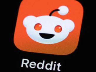 A Reddit app icon on a phone screen.