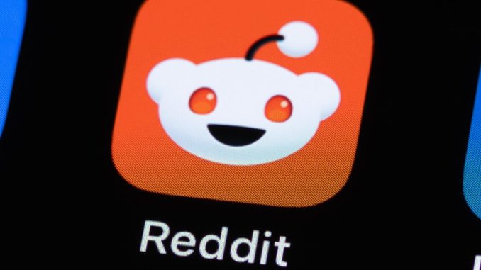 A Reddit app icon on a phone screen.