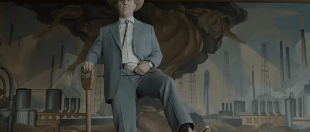 elderly man in a light blue suit and cowboy hat and boots holding a shovel