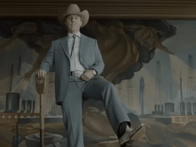 elderly man in a light blue suit and cowboy hat and boots holding a shovel